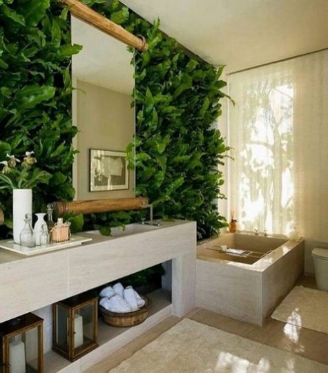 a bathroom done with lush greenery and neutral tiles for a natural feel