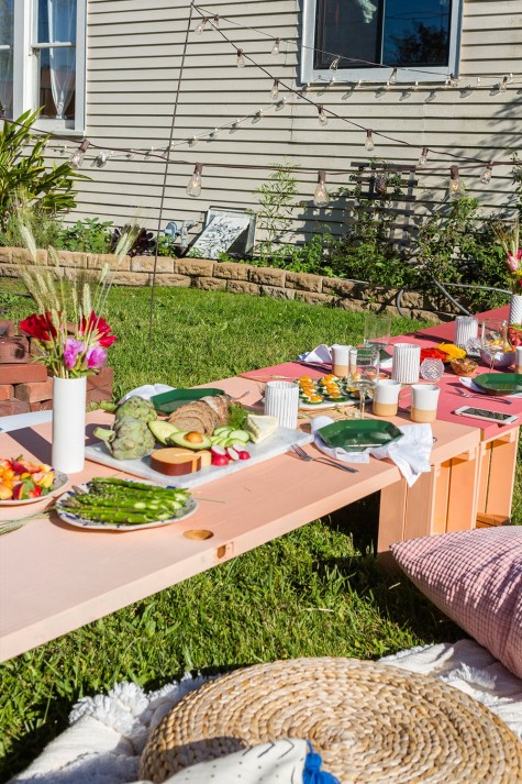 a low backyard table made of several Knagglig boxes by IKEA