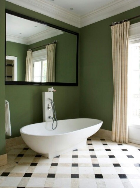 a whimsy bathroom with a large mirror over the bathtub for a catchy look