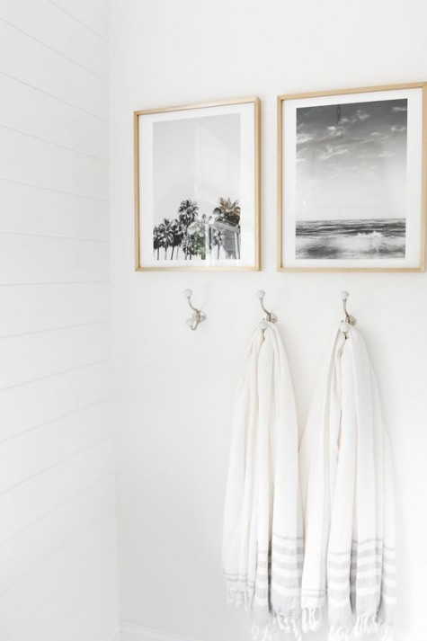 black and white coastal-inspired artworks in light-colored frames