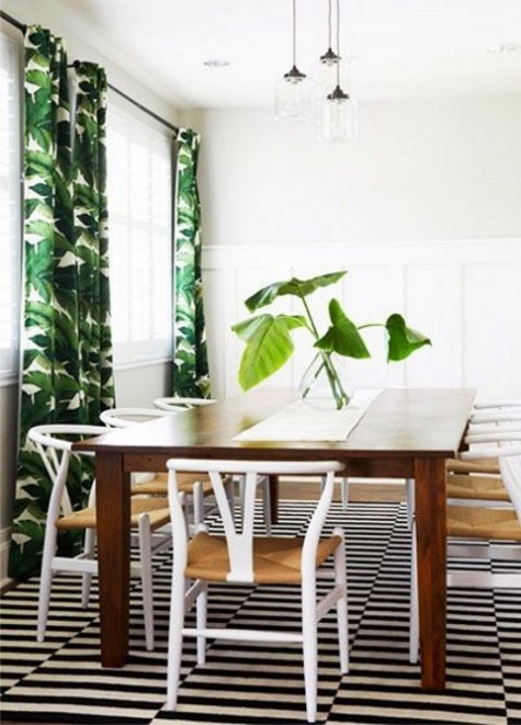 tropical leaf printed curtains add cheer to the monochromatic dining space