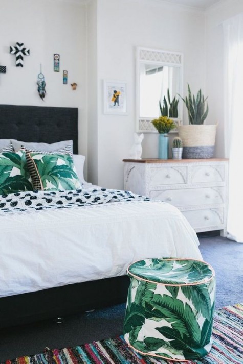 tropical leaf printed pillows and a small ottoman to match