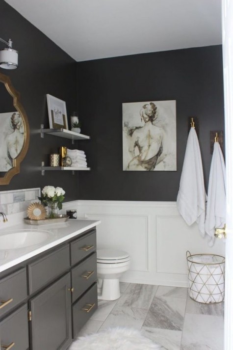 a black bathroom is spruced up with white wainscoting and a marble tile floor