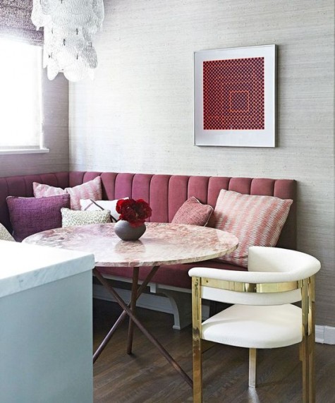 a burgundy upholstered bench and plum and pink pillows for a bold fall eating space
