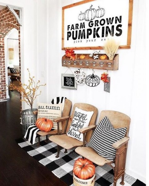 a farmhouse display with wheat, pumpkins, leaves and checked textiles
