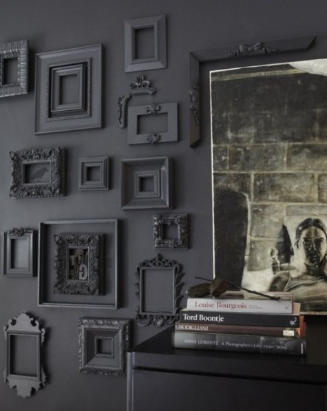 a moody space with various vintage empty frames for a refined touch