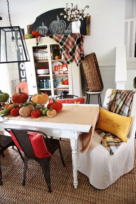 colorful velvet pumpkins and checked blankets take over this space and bring a fall feel