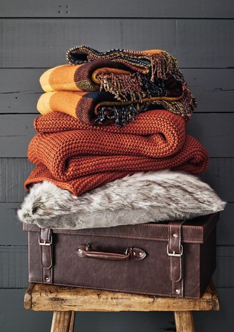 fall-colored knit, fabric and faux fur blankets to cuddle up