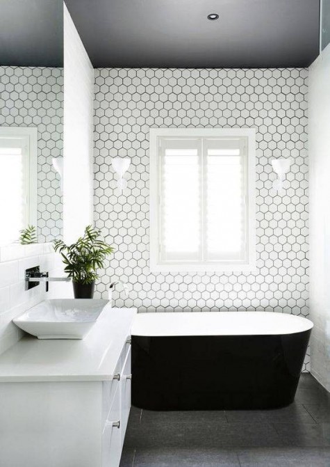 white hexagon tiles look amazing with black grout in a minimalist bathroom