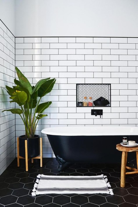 white long subway tiles with black grout and black hexagon ones with white grout