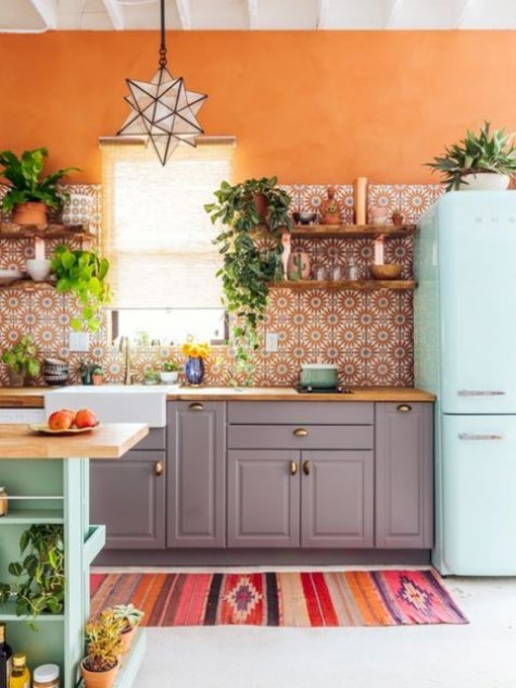 a colorful boho space with patterned tiles, a gypsy rug, potted greenery and bright furniture